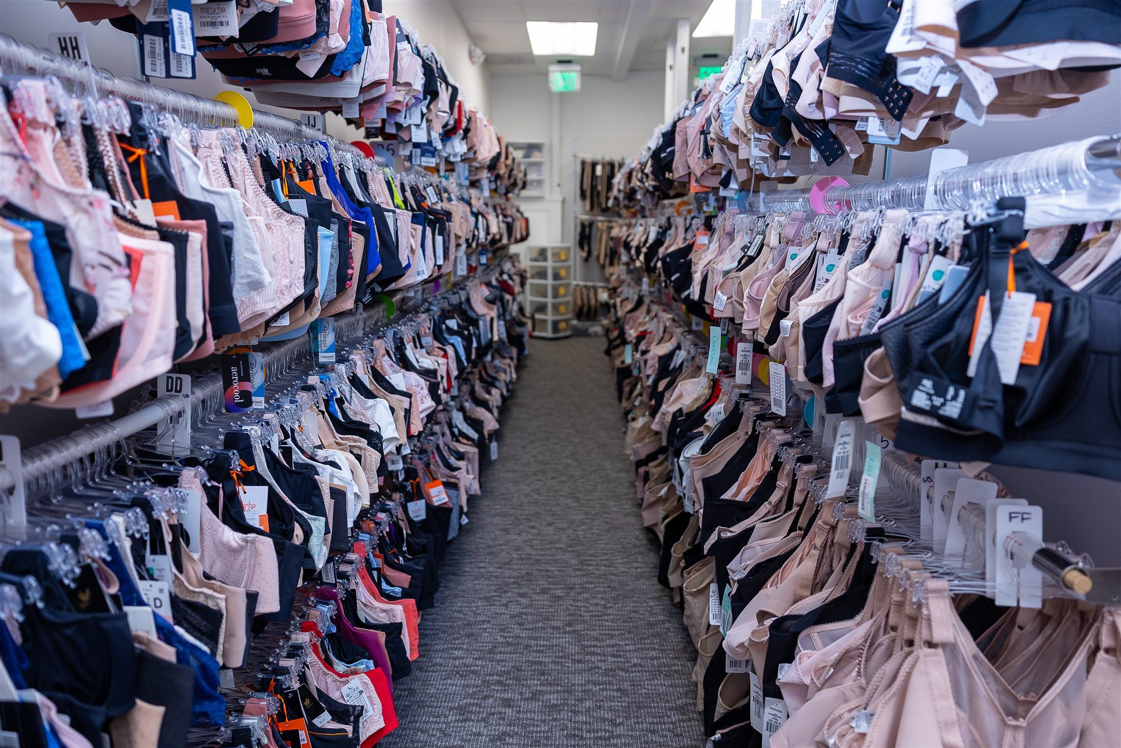 Sunny J's extensive bra inventory organized by size