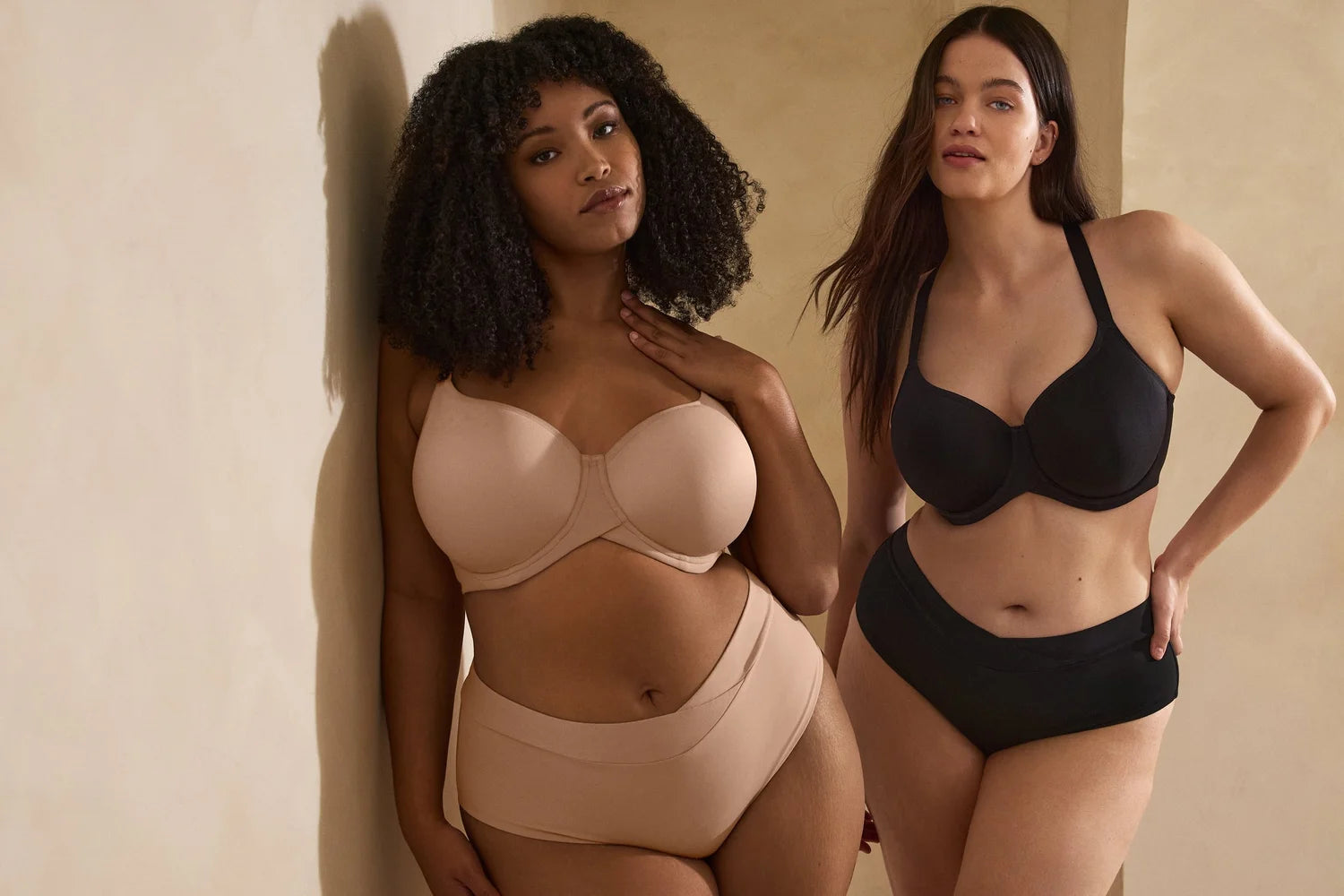 Two women wearing supportive bras in different styles